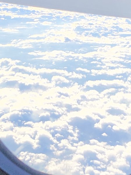 Clouds through the window of an aeroplane.